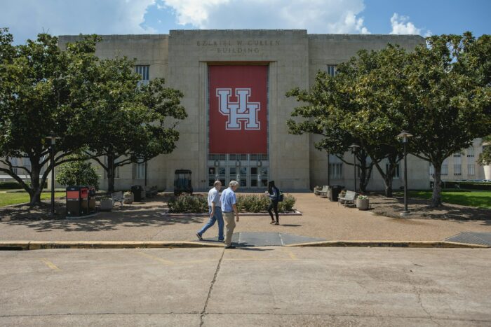 a few people walking outside of a building