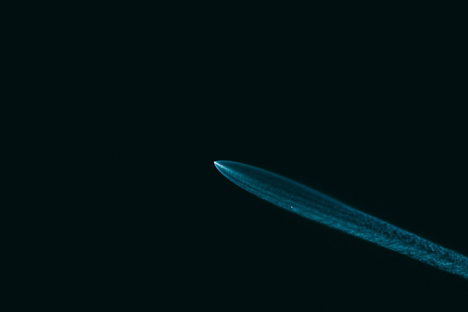 A close up of a toothbrush on a black background